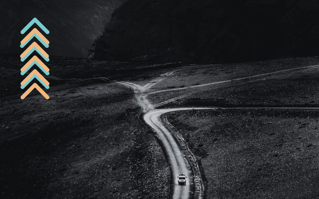 Dark, windy hillside road at night with a small car, overlaid by teal and peach chevron arrows on the left.